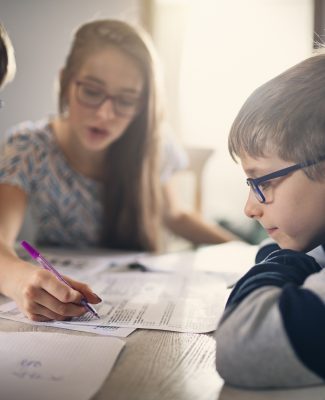 Elementary school kids doing homework at home